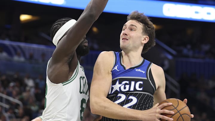 Nov 7, 2025; Orlando, Florida, USA; Orlando Magic forward Franz Wagner (22) drives to the basket past Boston Celtics center Neemias Queta (88) in the third quarter at Kia Center. Mandatory Credit: Nathan Ray Seebeck-Imagn Images