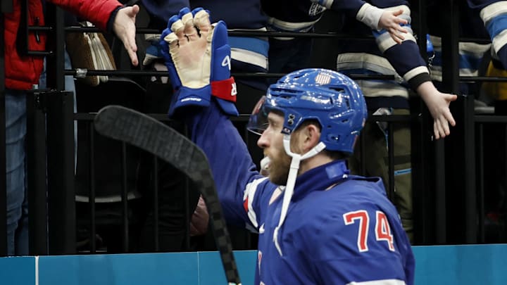Feb 14, 2026; Milan, Italy; Jaccob Slavin of United States and Brady Tkachuk of United States greet spectators at the end of the match against Denmark  in men's ice hockey group C play during the Milano Cortina 2026 Olympic Winter Games at Milano Santagiulia Ice Hockey Arena. Mandatory Credit: Geoff Burke-Imagn Images