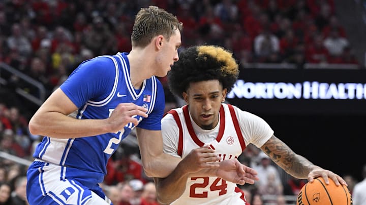 Dec 8, 2024; Louisville, Kentucky, USA;  Louisville Cardinals guard Chucky Hepburn (24) dribbles against Duke Blue Devils guard Cooper Flagg (2) during the second half at KFC Yum! Center. Duke defeated Louisville 76-65. Mandatory Credit: Jamie Rhodes-Imagn Images