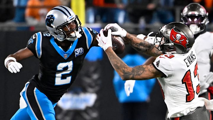 Dec 1, 2024; Charlotte, North Carolina, USA; Tampa Bay Buccaneers wide receiver Mike Evans (13) catches the ball as Carolina Panthers cornerback Michael Jackson (2) defends in overtime at Bank of America Stadium. Dec 1, 2024; Charlotte, North Carolina, USA; Tampa Bay Buccaneers wide receiver Mike Evans (13) catches the ball as Carolina Panthers cornerback Michael Jackson (2) defends in overtime at Bank of America Stadium.