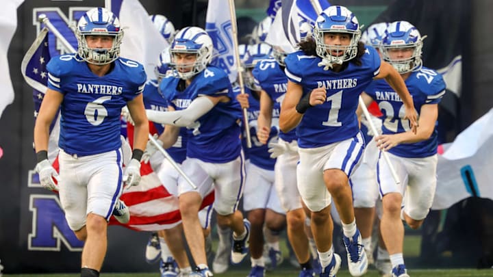 The Ford Panthers run onto the field before a Texas high school football showdown with Mineral Wells.