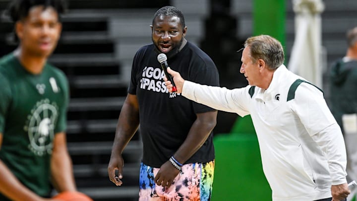 Michigan State's head coach Tom Izzo holds a microphone for former player Kelvin Torbert as he starts a \"Go Green, Go White\" cheer during open practice on Saturday, Oct. 2, 2021, at the Breslin Center in East Lansing.

Syndication Lansing State Journal