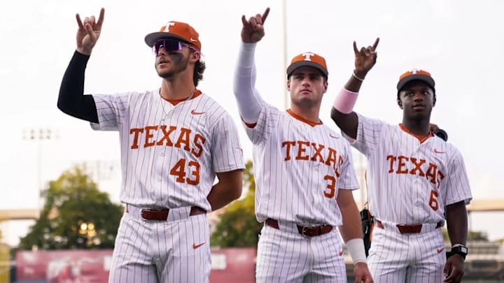 Texas Longhorns Aiden Robbins, Casey Borba and Anthony Pack Jr. throw up the Hook 'Em Horns.