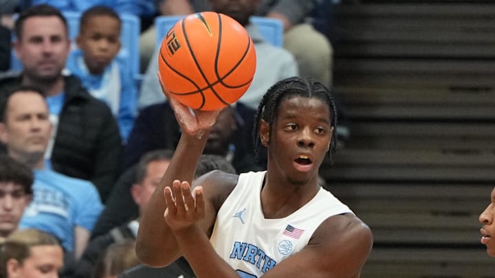 Feb 2, 2026; Chapel Hill, North Carolina, USA;  North Carolina Tar Heels forward Caleb Wilson (8) passes the ball as Syracuse Orange forward Donnie Freeman (1) defends in the first half at Dean E. Smith Center. Mandatory Credit: Bob Donnan-Imagn Images