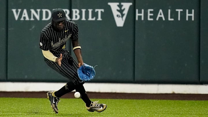 Vanderbilt center fielder RJ Austin (42) scoops up a single hit by Arkansas outfielder Justin Thomas Jr. (4) during the third inning at Hawkins Field in Nashville, Tenn., Friday, March 28, 2025. Vanderbilt center fielder RJ Austin (42) scoops up a single hit by Arkansas outfielder Justin Thomas Jr. (4) during the third inning at Hawkins Field in Nashville, Tenn., Friday, March 28, 2025.