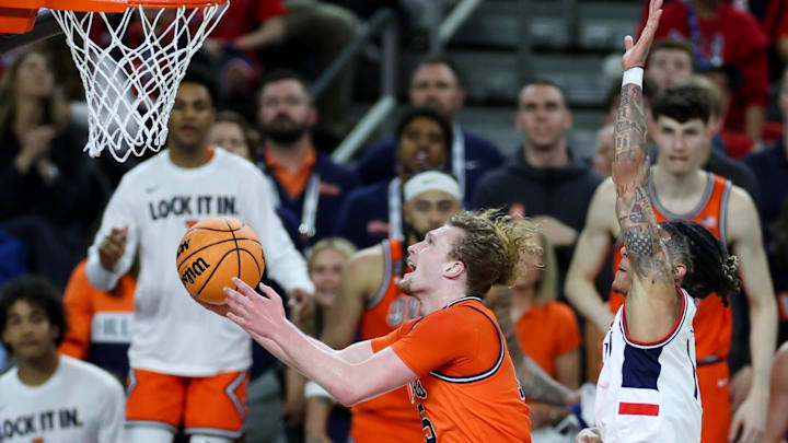 Apr 4, 2026; Indianapolis, IN, USA; UConn Huskies guard Solo Ball (1) fouls Illinois Fighting Illini forward Jake Davis (15) in the second half during a semifinal of the Final Four of the men's 2026 NCAA Tournament at Lucas Oil Stadium. Mandatory Credit: Trevor Ruszkowski-Imagn Images