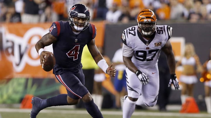 Sep 14, 2017; Cincinnati, OH, USA; Houston Texans quarterback Deshaun Watson (4) runs against Cincinnati Bengals defensive tackle Geno Atkins (97) during the second half at Paul Brown Stadium. Mandatory Credit: David Kohl-Imagn Images