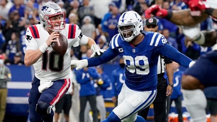 Indianapolis Colts defensive tackle DeForest Buckner (99) chases after New England Patriots quarterback Mac Jones (10) as he scrambles in the pocket Saturday, Dec. 18, 2021, during a game against the New England Patriots at Lucas Oil Stadium in Indianapolis.