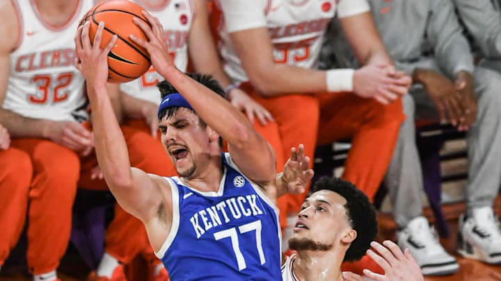 Dec 3, 2024; Clemson, South Carolina, USA; Kentucky guard Kerr Kriisa (77) rebounds near Clemson guard Chase Hunter (1) during the first half at Littlejohn Coliseum. Mandatory Credit: Ken Ruinard-Imagn Images