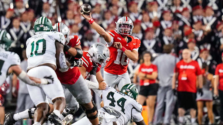 Ohio State Buckeyes quarterback Julian Sayin (10) throws one with good protection.