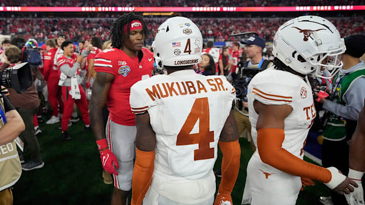 Ohio State Buckeyes wide receiver Jeremiah Smith (4) talks to Texas Longhorns defensive back Andrew Mukuba (4) after the Buckeyes beat the Longhorns 28-14 in the Cotton Bowl Classic during the College Football Playoff semifinal game at AT&T Stadium in Arlington, Texas on January, 10, 2025. Ohio State Buckeyes wide receiver Jeremiah Smith (4) talks to Texas Longhorns defensive back Andrew Mukuba (4) after the Buckeyes beat the Longhorns 28-14 in the Cotton Bowl Classic during the College Football Playoff semifinal game at AT&T Stadium in Arlington, Texas on January, 10, 2025.