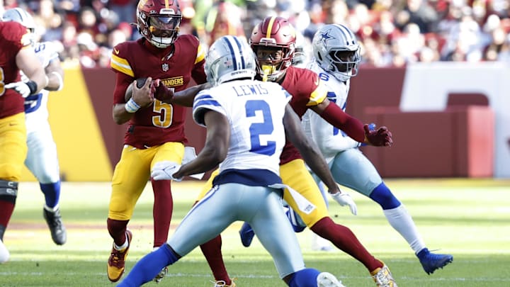 Washington Commanders quarterback Jayden Daniels runs with the ball as Dallas Cowboys corner Jourdam Lewis