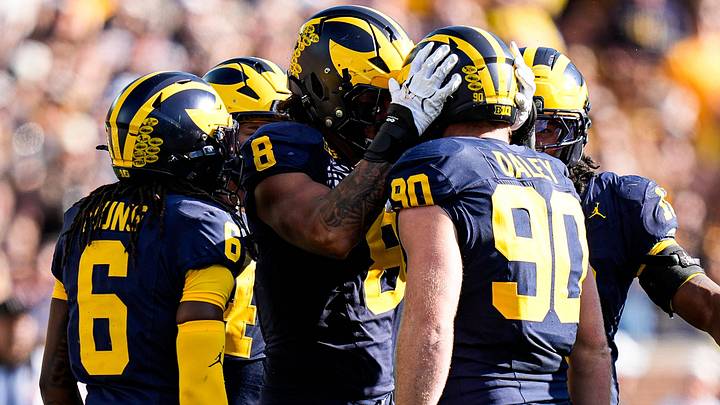 Michigan defensive end Dom Nichols and defensive end John Henry Daley celebrates a play against Iowa Michigan defensive end Dom Nichols and defensive end John Henry Daley celebrates a play against Iowa