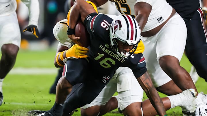 Nov 16, 2024; Columbia, South Carolina, USA; South Carolina Gamecocks quarterback LaNorris Sellers (16) is sacked by Missouri Tigers defensive tackle Chris McClellan (7) in the second half at Williams-Brice Stadium. Mandatory Credit: Jeff Blake-Imagn Images