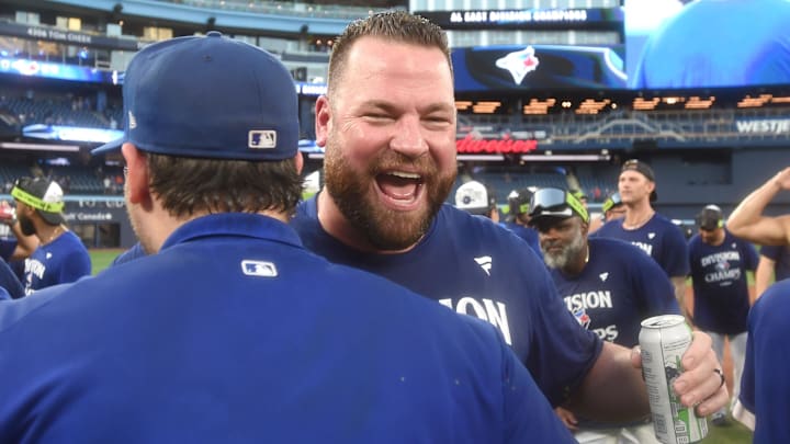 Sep 28, 2025; Toronto, Ontario, CAN;  Toronto Blue Jays manager John Schneider (14) celebrates with teammates after a win over the Tampa Bay Rays clinched first place in the American League East Division at Rogers Centre. 