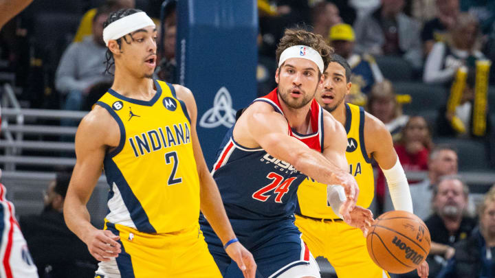 Dec 9, 2022; Indianapolis, Indiana, USA; Washington Wizards forward Corey Kispert (24) passes the ball while Indiana Pacers guard Andrew Nembhard (2) defends in the first quarter at Gainbridge Fieldhouse. Mandatory Credit: Trevor Ruszkowski-USA TODAY Sports