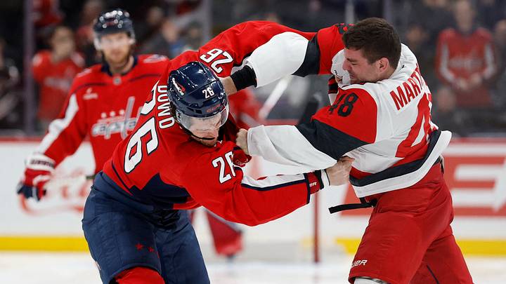 Dec 11, 2025; Washington, District of Columbia, USA; Washington Capitals center Nic Dowd (26) fights Carolina Hurricanes left wing Jordan Martinook (48) during the third period at Capital One Arena. Mandatory Credit: Geoff Burke-Imagn Images