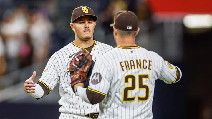 Apr 14, 2026; San Diego, California, USA; San Diego Padres third baseman Manny Machado (13) celebrates with first baseman Ty France (25) after defeating the Seattle Mariners at Petco Park. Mandatory Credit: David Frerker-Imagn Images