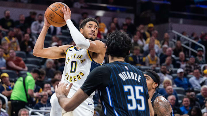Indiana Pacers guard Tyrese Haliburton (0) passes the ball while Orlando Magic center Goga Bitadze (35) defends in the first half at Gainbridge Fieldhouse.