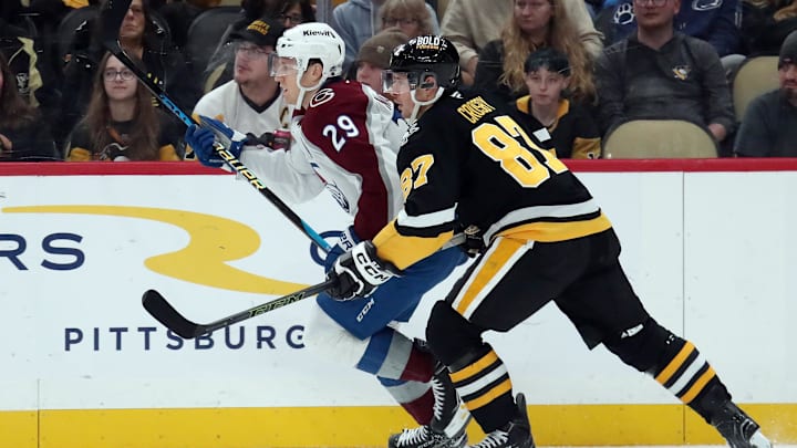 Dec 10, 2024; Pittsburgh, Pennsylvania, USA;  Colorado Avalanche center Nathan MacKinnon (29) and Pittsburgh Penguins center Sidney Crosby (87) in action during the first period at PPG Paints Arena. Mandatory Credit: Charles LeClaire-Imagn Images