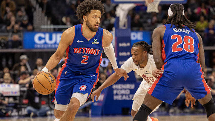 Detroit Pistons guard Cade Cunningham (2) moves the ball up court as center Isaiah Stewart (28) sets a pick on Cleveland Cavaliers guard Darius Garland (10) during the first half at Little Caesars Arena.