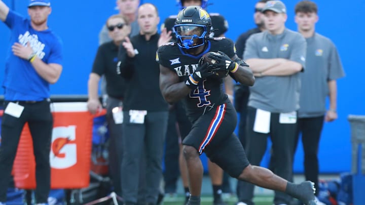 Kansas Jayhawks running back Leshon Williams (4) runs the ball during the first half of the game against West Virginia Mountaineers at David Booth Kansas Memorial Stadium on Sept. 20, 2025. Kansas Jayhawks running back Leshon Williams (4) runs the ball during the first half of the game against West Virginia Mountaineers at David Booth Kansas Memorial Stadium on Sept. 20, 2025.