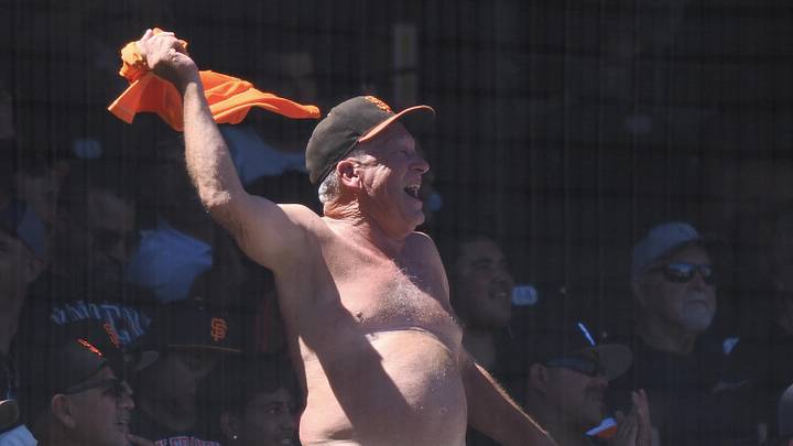 San Francisco, California, USA; A San Francisco Giants fan waves his shirt during the eighth inning against the Washington Nationals at Oracle Park. Mandatory Credit: Kelley L Cox-Imagn Images