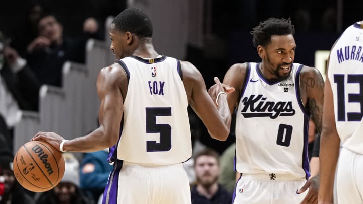 Dec 29, 2023; Atlanta, Georgia, USA; Sacramento Kings guard De'Aaron Fox (5) reacts with guard Malik Monk (0). Dec 29, 2023; Atlanta, Georgia, USA; Sacramento Kings guard De'Aaron Fox (5) reacts with guard Malik Monk (0).