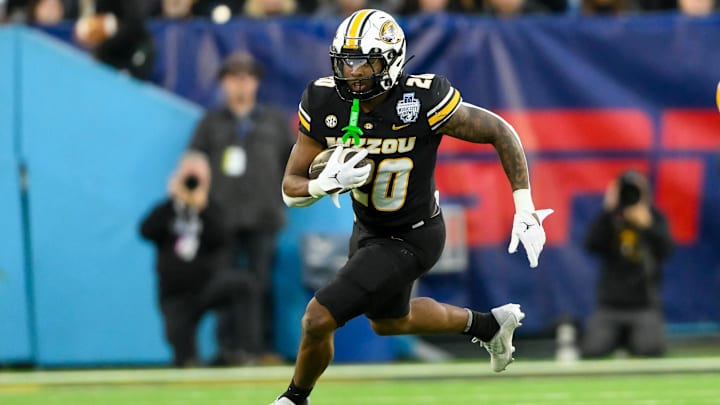 Dec 30, 2024; Nashville, TN, USA;  Missouri Tigers running back Jamal Roberts (20) runs the ball against the Iowa Hawkeyes during the second half at Nissan Stadium. Mandatory Credit: Steve Roberts-Imagn Images
