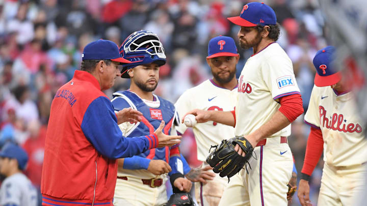 Philadelphia Phillies pitcher Jordan Romano (68) hands the ball to manager Rob Thomson (59) after being removed from the game.