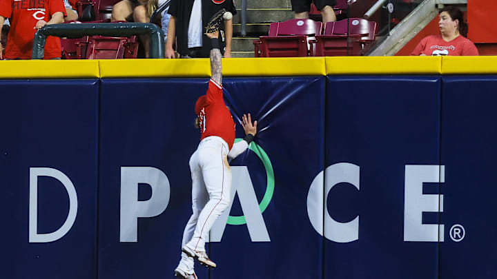 Jun 17, 2025; Cincinnati, Ohio, USA; Cincinnati Reds outfielder Jake Fraley (27) attempts to catch a home run hit by Minnesota Twins outfielder Harrison Bader (not pictured) in the sixth inning at Great American Ball Park. Mandatory Credit: Katie Stratman-Imagn Images