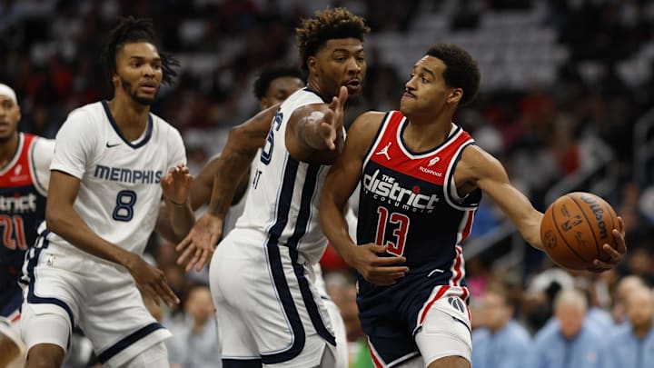 Oct 28, 2023; Washington, District of Columbia, USA; Washington Wizards guard Jordan Poole (13) passes the ball as Memphis Grizzlies guard Marcus Smart (36) defends in the first quarter at Capital One Arena. Mandatory Credit: Geoff Burke-Imagn Images