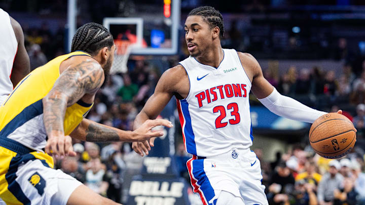 Nov 29, 2024; Indianapolis, Indiana, USA; Detroit Pistons guard Jaden Ivey (23) dribbles the ball while Indiana Pacers forward Obi Toppin (1) defends in the second half  at Gainbridge Fieldhouse. Mandatory Credit: Trevor Ruszkowski-Imagn Images