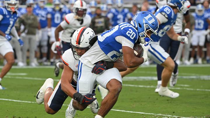 Nov 15, 2025; Durham, North Carolina, USA; Virginia Cavaliers linebacker Landon Danley (32) tackles Duke Blue Devils running back Nate Sheppard (20) during the first quarter at Wallace Wade Stadium. Mandatory Credit: Zachary Taft-Imagn Images Nov 15, 2025; Durham, North Carolina, USA; Virginia Cavaliers linebacker Landon Danley (32) tackles Duke Blue Devils running back Nate Sheppard (20) during the first quarter at Wallace Wade Stadium. Mandatory Credit: Zachary Taft-Imagn Images