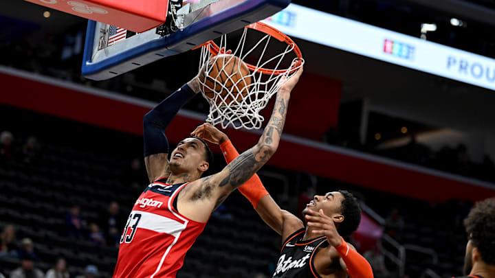 Jan 27, 2024; Detroit, Michigan, USA; Washington Wizards forward Kyle Kuzma (33) dunks the ball over Detroit Pistons guard Jaden Ivey (23) in the fourth quarter at Little Caesars Arena. Mandatory Credit: Lon Horwedel-USA TODAY Sports