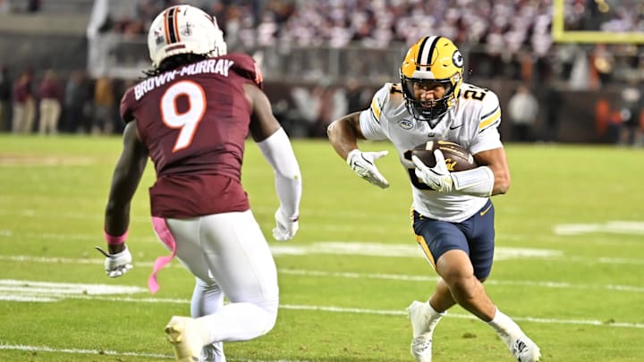 Oct 24, 2025; Blacksburg, Va.; California wide receiver Jacob de Jesus (21) runs after a catch as Virginia Tech cornerback Isaiah Brown-Murray (9) defends.