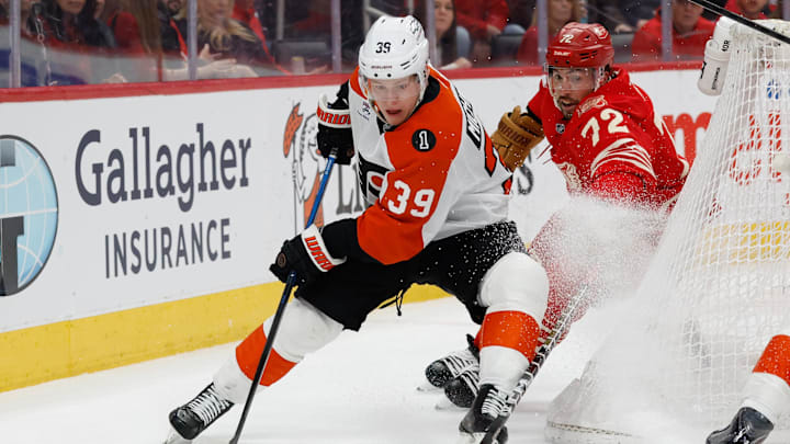 Mar 28, 2026; Detroit, Michigan, USA;  Philadelphia Flyers right wing Matvei Michkov (39) skates with the puck chased by Detroit Red Wings defenseman Justin Faulk (72) in the first period at Little Caesars Arena. Mandatory Credit: Rick Osentoski-Imagn Images
