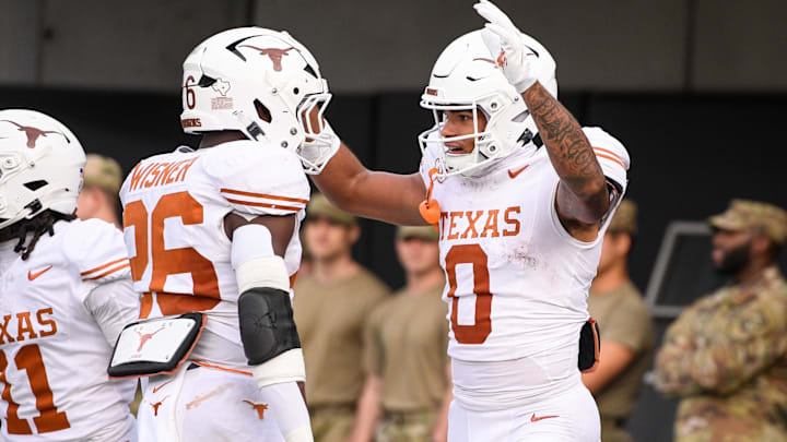 Oct 26, 2024; Nashville, Tennessee, USA; Texas Longhorns running back Quintrevion Wisner (26) celebrates the touchdown of wide receiver DeAndre Moore Jr. (0) against the Vanderbilt Commodores during the first half at FirstBank Stadium. Mandatory Credit: Steve Roberts-Imagn Images Oct 26, 2024; Nashville, Tennessee, USA; Texas Longhorns running back Quintrevion Wisner (26) celebrates the touchdown of wide receiver DeAndre Moore Jr. (0) against the Vanderbilt Commodores during the first half at FirstBank Stadium. Mandatory Credit: Steve Roberts-Imagn Images