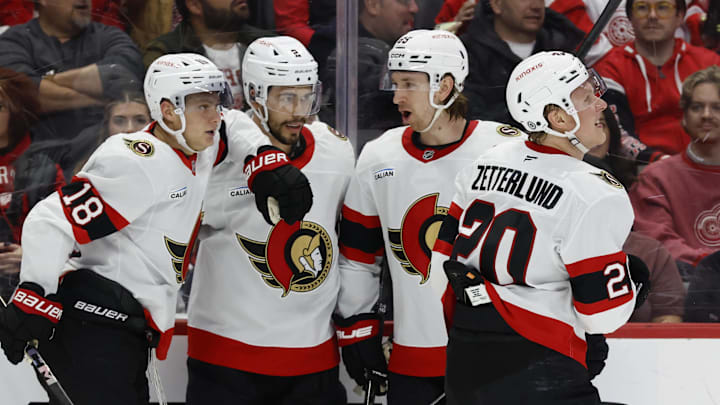Mar 27, 2025; Detroit, Michigan, USA;  Ottawa Senators center Tim Stützle (18) is congratulated by teammates after scoring in the first period against the Detroit Red Wings at Little Caesars Arena. Mandatory Credit: Rick Osentoski-Imagn Images
