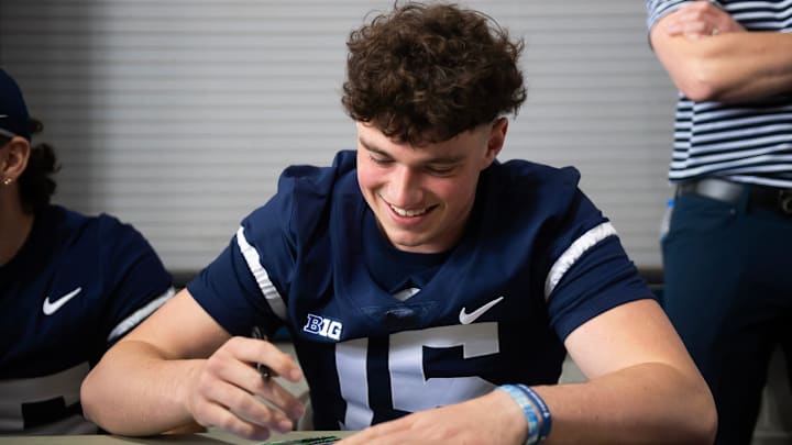 Penn State quarterback Drew Allar signs a poster before the start of the annual Blue-White Game at Beaver Stadium. Penn State quarterback Drew Allar signs a poster before the start of the annual Blue-White Game at Beaver Stadium.