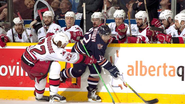 Jun 17, 2006; Edmonton, Alberta, CAN; Edmonton Oilers left wing Sergei Samsonov (12) and Carolina Hurricanes defenseman Mike Commodore (22) against the boards during game six of the Stanley Cup Finals at Rexall Place. Credit: Lou Capozzola-USA TODAY NETWORK