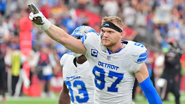 Sep 22, 2024; Glendale, Arizona, USA;  Detroit Lions defensive end Aidan Hutchinson (97) and defensive end Josh Paschal (93) celebrate after stopping the Arizona Cardinals on 4th and 1 in the second half at State Farm Stadium. Mandatory Credit: Matt Kartozian-Imagn Images