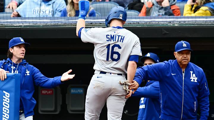 May 28, 2025; Cleveland, Ohio, USA; Los Angeles Dodgers catcher Will Smith (16) celebrates after scoring with manager Dave Roberts, right, during the fourth inning against the Cleveland Guardians at Progressive Field. Mandatory Credit: Ken Blaze-Imagn Images