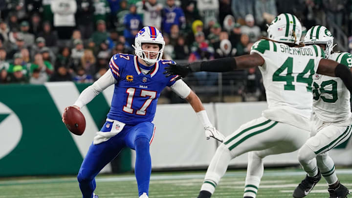 Oct 14, 2024; East Rutherford, New Jersey, USA; Buffalo Bills quarterback Josh Allen (17) scrambles as New York Jets defensive end Will McDonald IV (99) and New York Jets linebacker Jamien Sherwood (44) close in during the first half at MetLife Stadium.