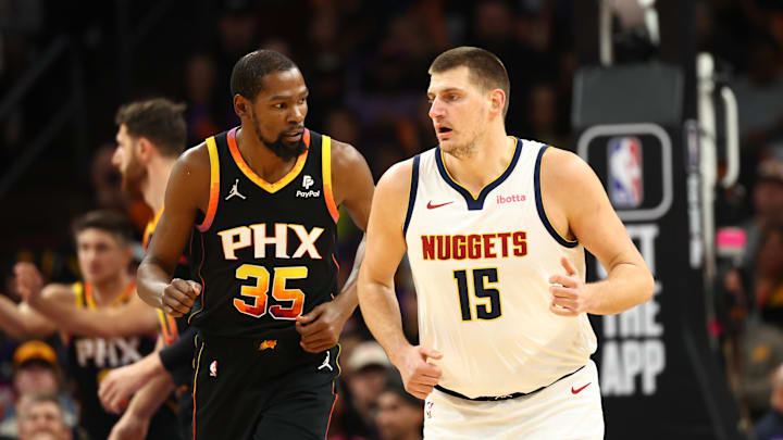Dec 1, 2023; Phoenix, Arizona, USA; Phoenix Suns forward Kevin Durant (35) against Denver Nuggets center Nikola Jokic (15) in the first half at Footprint Center. Mandatory Credit: Mark J. Rebilas-Imagn Images