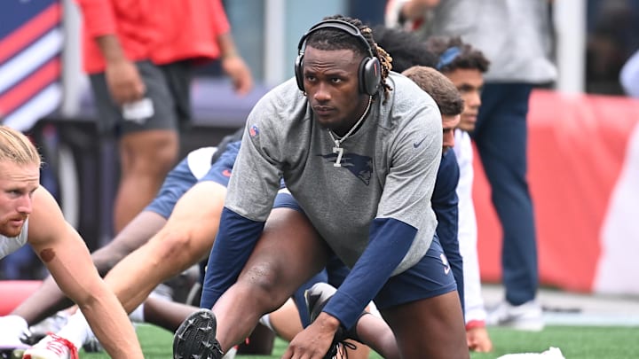 New England Patriots quarterback Joe Milton III warms up before a game against the Carolina Panthers.
