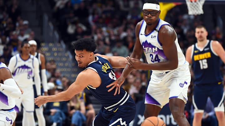 Mar 27, 2026; Denver, Colorado, USA; Denver Nuggets forward Spencer Jones (21) steals the ball from Utah Jazz center Oscar Tshiebwe (34) during the second half at Ball Arena. Mandatory Credit: Christopher Hanewinckel-Imagn Images