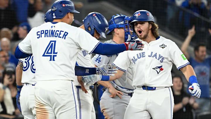 Oct 24, 2025; Toronto, Ontario, CAN; Toronto Blue Jays right fielder Addison Barger (47) celebrates with teammates after hitting a grand slam against the Los Angeles Dodgers in the sixth inning during game one of the 2025 MLB World Series at Rogers Centre. Oct 24, 2025; Toronto, Ontario, CAN; Toronto Blue Jays right fielder Addison Barger (47) celebrates with teammates after hitting a grand slam against the Los Angeles Dodgers in the sixth inning during game one of the 2025 MLB World Series at Rogers Centre.
