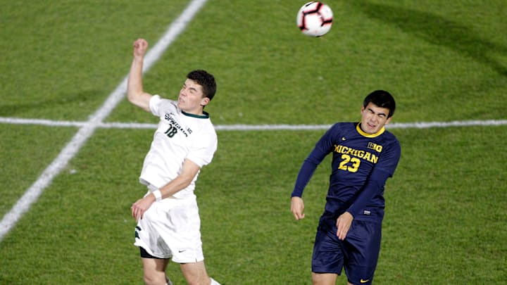 Michigan State's Michael Miller, left, and Michigan's Marc Ybarra (23) vie for a header, Tuesday, Oct. 23, 2018, in East Lansing, Mich. The teams played to a 1-1 draw.

Michigan At Michigan State Men S Soccer