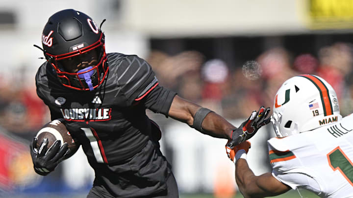 Oct 19, 2024; Louisville, Kentucky, USA; Louisville Cardinals wide receiver Ja'Corey Brooks (1) runs the ball against Miami Hurricanes defensive back D'Yoni Hill (19) during the second half at L&N Federal Credit Union Stadium. Miami defeated Louisville 52-45. Oct 19, 2024; Louisville, Kentucky, USA; Louisville Cardinals wide receiver Ja'Corey Brooks (1) runs the ball against Miami Hurricanes defensive back D'Yoni Hill (19) during the second half at L&N Federal Credit Union Stadium. Miami defeated Louisville 52-45.